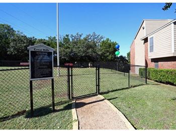 A yard with a chain link fence and a sign